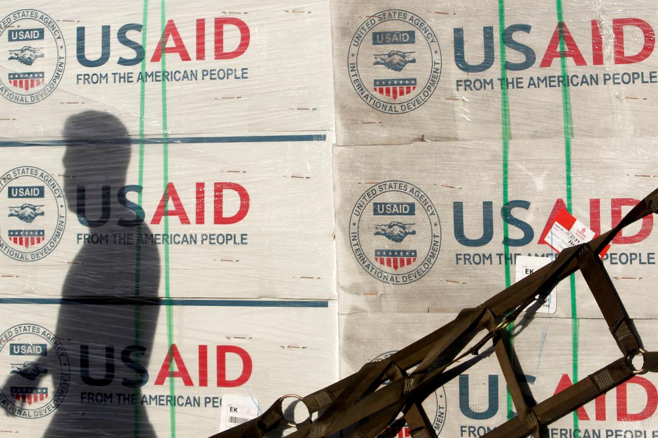 The shadow of a Philippine Army personnel is cast on boxes of relief items from USAID for the victims of super typhoon Haiyan, at Villamor Air Base, in Manila, Philippines, on November 13, 2013. 