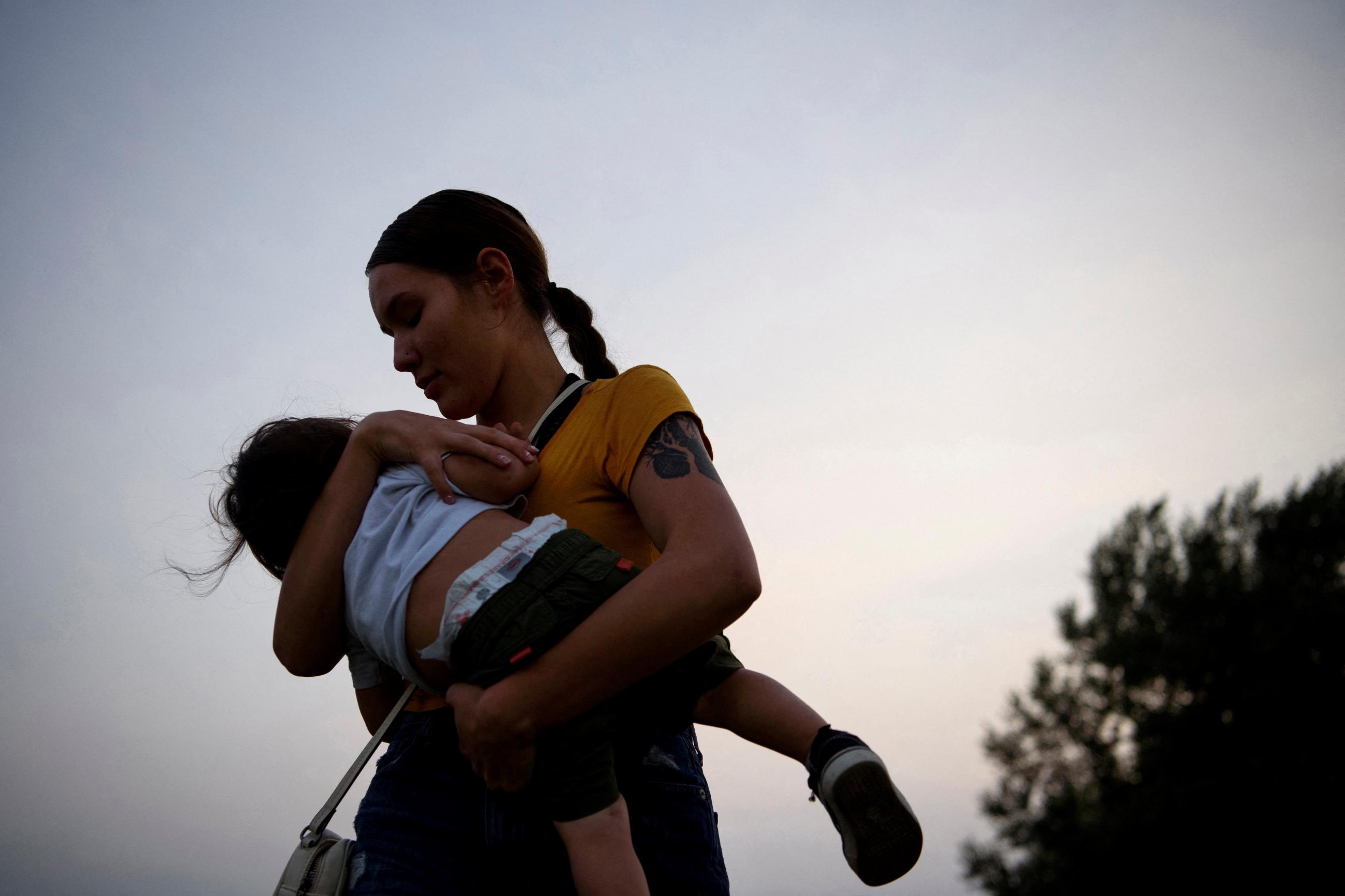 A mother holds her child, at the Fort Wagner Casino and Hotel, on the Yankton Indian Reservation, in South Dakota, on September 9, 2021.