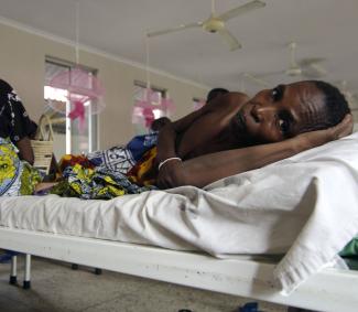 A cervical cancer patient lays on a bed in the female ward of a cancer institute, in Dar es Salaam, Tanzania, on November 11, 2009. 